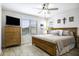 Serene main bedroom with a wooden bed frame, dresser, ceiling fan, and natural light at 1973 N Lewis Pl, Casa Grande, AZ 85122