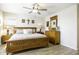 Comfortable main bedroom features hardwood floors, wooden furniture, ceiling fan and white walls at 1973 N Lewis Pl, Casa Grande, AZ 85122