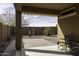 Covered patio with view of desert landscaping, privacy wall and outdoor seating at 1973 N Lewis Pl, Casa Grande, AZ 85122