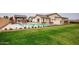 A large backyard with a pool, covered patio, and manicured lawn, perfect for outdoor living at 19777 E Ivy Ln, Queen Creek, AZ 85142