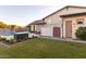 Spacious backyard with a pool, lawn and a outdoor seating at 19777 E Ivy Ln, Queen Creek, AZ 85142
