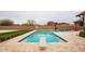 An expansive backyard with a pool, diving board, basketball hoop, and outdoor seating area at 19777 E Ivy Ln, Queen Creek, AZ 85142