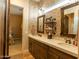 Bathroom featuring a double vanity with quartz countertops and tile backsplash at 19777 E Ivy Ln, Queen Creek, AZ 85142