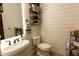 Charming powder room with shiplap walls and modern fixtures at 19777 E Ivy Ln, Queen Creek, AZ 85142