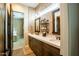 Elegant bathroom featuring a double vanity with quartz countertops, tile backsplash, and modern fixtures at 19777 E Ivy Ln, Queen Creek, AZ 85142