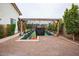 View of the home's state-of-the-art backyard batting cage with a pitching mound and landscaped perimeter at 19777 E Ivy Ln, Queen Creek, AZ 85142