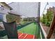 Exterior shot of a private batting cage with synthetic turf and safety netting in a well-maintained backyard at 19777 E Ivy Ln, Queen Creek, AZ 85142