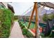 Landscaped paver walkway leads to the sports court, which features a high-end batting cage at 19777 E Ivy Ln, Queen Creek, AZ 85142