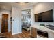 Stylish bedroom featuring wood floors, adjacent kitchenette and a view of a bedroom at 19777 E Ivy Ln, Queen Creek, AZ 85142