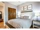 Comfortable bedroom featuring a large bed, wood flooring and 'Live Laugh Love' decor at 19777 E Ivy Ln, Queen Creek, AZ 85142