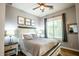 Comfortable bedroom features a ceiling fan, natural light and calming decor at 19777 E Ivy Ln, Queen Creek, AZ 85142