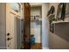 Entryway closet with wood flooring, shelving, decor and rustic wood door at 19777 E Ivy Ln, Queen Creek, AZ 85142