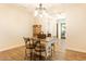 Dining room with hardwood floors, bar stools, and view into other rooms at 19777 E Ivy Ln, Queen Creek, AZ 85142
