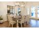 Dining room with wood floors, chandelier lighting and view of a landscaped backyard at 19777 E Ivy Ln, Queen Creek, AZ 85142