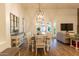 Bright dining area with wooden floors, decorative lighting, and views of the outdoor patio at 19777 E Ivy Ln, Queen Creek, AZ 85142