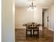 The dining room boasts hardwood floors, chandelier lighting, and a seamless transition to the kitchen at 19777 E Ivy Ln, Queen Creek, AZ 85142