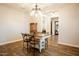Dining room with a wood table, metal chairs, and a view to the kitchen at 19777 E Ivy Ln, Queen Creek, AZ 85142