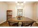 Dining room features wood table and chairs, hardwood floors, and elegant chandelier lighting at 19777 E Ivy Ln, Queen Creek, AZ 85142
