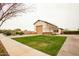 Detached garage structure with a large garage door and well-maintained lawn at 19777 E Ivy Ln, Queen Creek, AZ 85142