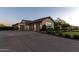 An attached three-car garage and large driveway provides space for vehicles and storage, and complements the home's design at 19777 E Ivy Ln, Queen Creek, AZ 85142