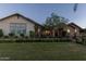 Charming single-story home with a brick exterior, manicured landscaping, and verdant lawn at 19777 E Ivy Ln, Queen Creek, AZ 85142