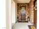 Inviting front entry with a solid wood door, decorative wreath, and stylish lanterns at 19777 E Ivy Ln, Queen Creek, AZ 85142
