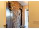 A close up of a wooden front door with a wreath inside an entryway with brick and neutral walls at 19777 E Ivy Ln, Queen Creek, AZ 85142
