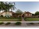 Beautifully landscaped front yard with mature trees and a welcoming entryway enhance this charming home's curb appeal at 19777 E Ivy Ln, Queen Creek, AZ 85142