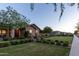 Charming single-story home with a brick exterior, manicured landscaping, and a verdant lawn at 19777 E Ivy Ln, Queen Creek, AZ 85142