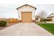 Exterior view of garage with extended driveway and green grass at 19777 E Ivy Ln, Queen Creek, AZ 85142