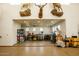 Large garage space with high ceilings, mounted animal decorations, and a work bench at 19777 E Ivy Ln, Queen Creek, AZ 85142