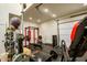 A spacious garage with a home gym set up at 19777 E Ivy Ln, Queen Creek, AZ 85142