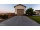 Detached garage boasts neutral paint, brown trim and doors, brick accents and gray driveway at 19777 E Ivy Ln, Queen Creek, AZ 85142