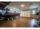 Well-lit garage featuring a boat on a trailer and ample space for vehicle storage at 19777 E Ivy Ln, Queen Creek, AZ 85142