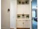 Hallway with white cabinets, decorative plants and an entrance to the bedroom at 19777 E Ivy Ln, Queen Creek, AZ 85142