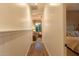 Hallway with light colored walls that leads to the living room, and a bedroom at 19777 E Ivy Ln, Queen Creek, AZ 85142