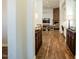 Elegant hallway with hardwood floors leading to a spacious living area with a stone fireplace at 19777 E Ivy Ln, Queen Creek, AZ 85142