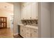Hallway with custom cabinets and quartz counters offers a seamless transition to the rest of the home at 19777 E Ivy Ln, Queen Creek, AZ 85142