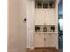 Hallway with a storage cabinet, decorative plants and a small, classic clock at 19777 E Ivy Ln, Queen Creek, AZ 85142