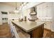 Stunning kitchen featuring a large center island with seating and modern stainless steel appliances at 19777 E Ivy Ln, Queen Creek, AZ 85142