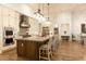 Modern kitchen featuring a large island with seating and stainless steel appliances at 19777 E Ivy Ln, Queen Creek, AZ 85142