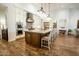 Well-equipped kitchen with a large center island, modern lighting, and beautiful wood flooring at 19777 E Ivy Ln, Queen Creek, AZ 85142