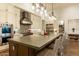 Spacious kitchen with a large island, stainless steel range hood, and pendant lighting at 19777 E Ivy Ln, Queen Creek, AZ 85142