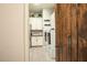 Bright laundry room featuring front load machines, tiled floors, and cabinetry for storage and folding at 19777 E Ivy Ln, Queen Creek, AZ 85142