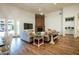Living room boasts stone fireplace, wood floors, and open floor plan at 19777 E Ivy Ln, Queen Creek, AZ 85142