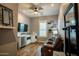 Cozy living room with wood floors, a wet bar, comfortable seating, and a mounted TV at 19777 E Ivy Ln, Queen Creek, AZ 85142