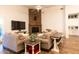 Spacious living room with stone fireplace, ceiling fan, and shiplap accent wall at 19777 E Ivy Ln, Queen Creek, AZ 85142