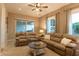 Living room with an open floorplan featuring neutral colored walls, large windows, and comfortable seating at 19777 E Ivy Ln, Queen Creek, AZ 85142