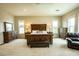 Spacious main bedroom with a seating area, bedside tables and dressers at 19777 E Ivy Ln, Queen Creek, AZ 85142