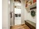 Mudroom features built-in bench with storage and an open view into the laundry room at 19777 E Ivy Ln, Queen Creek, AZ 85142